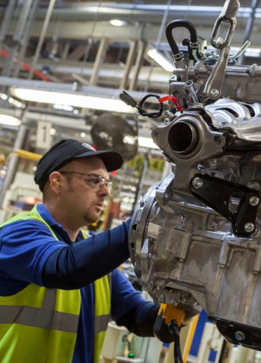 Technician working on engine.