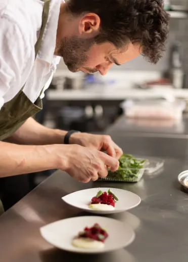 A man preparing food in the kitchen.