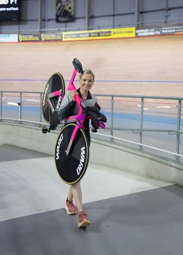 Ciara Oliva holding her bike over her shoulders