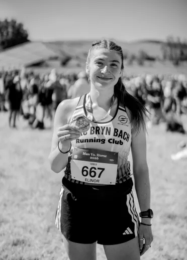 A runner showing their medal at the end of the Man vs Horse race in Wales