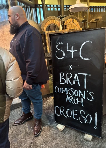 A man standing next to a sign.