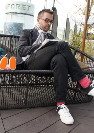 Illustrator Jonathan Edwards sitting on a bench