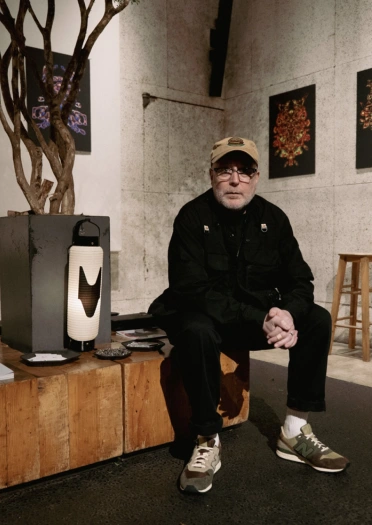 Artist Mark James sitting on a bench