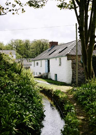 Stream and White washed buildings Melin Tregwynt 