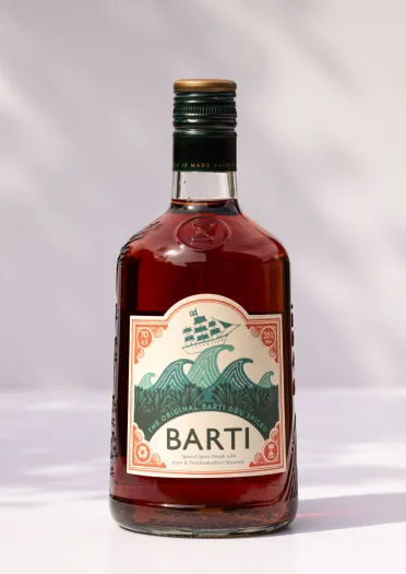 A bottle of Barti Rum against a white background