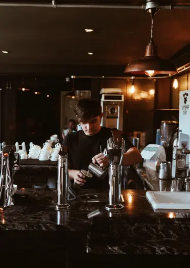 A person pouring coffee into a cup