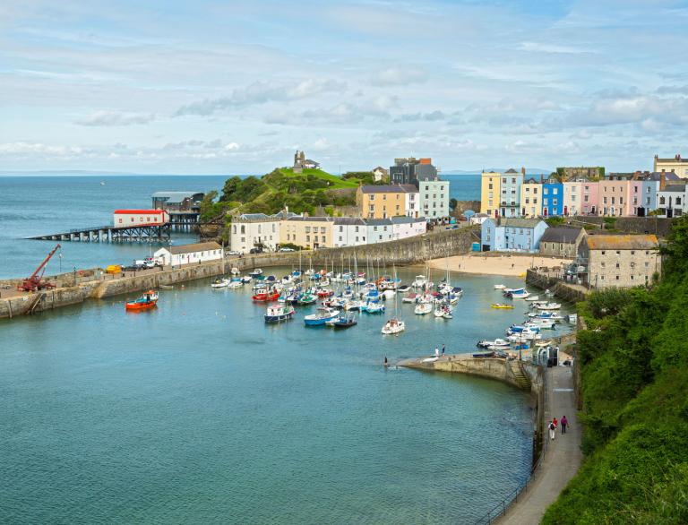 Wide angle image of Tenby taken from the sea with harbour, houses and lifeboat station