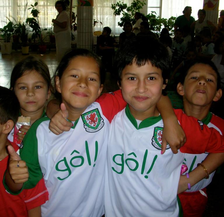 A group of children wearing Wales football shirts
