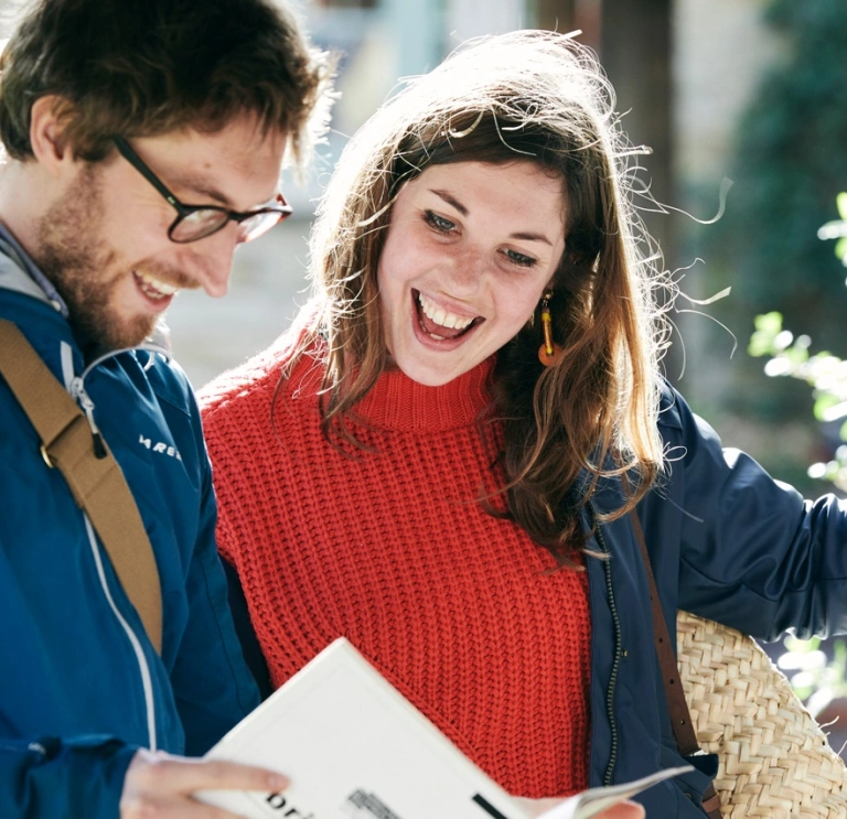 Two people looking at a book