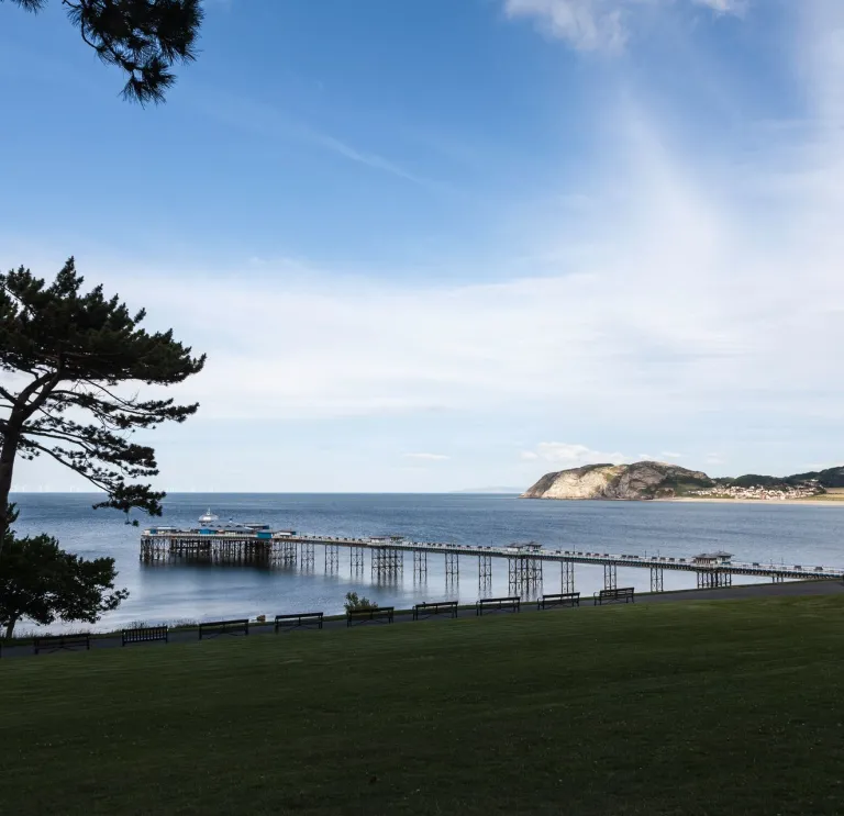 A view of the pier stretching out over blue water.