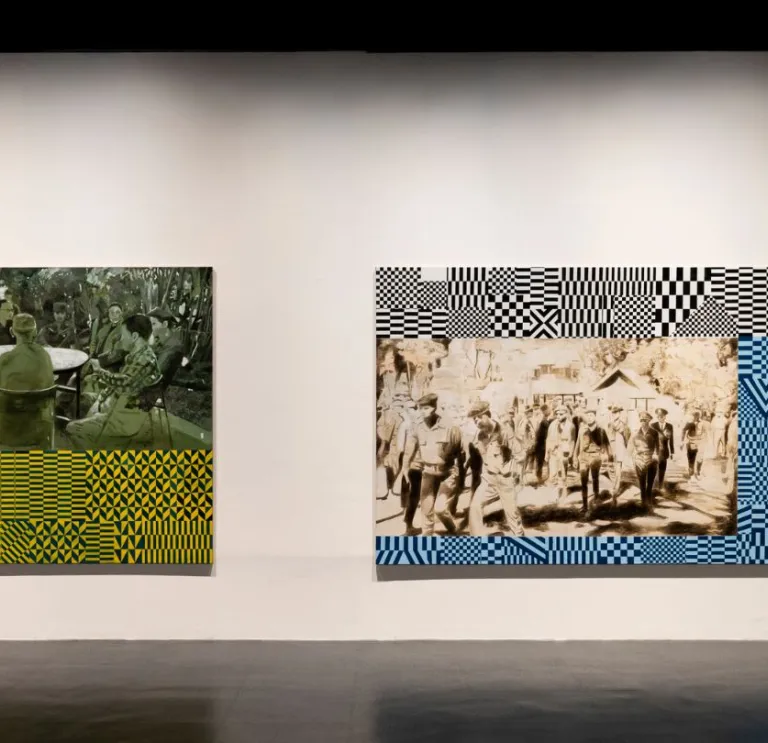 Two large mixed-media artworks hang on a gallery wall, each combining archival-style figurative scenes with bold geometric patterns.