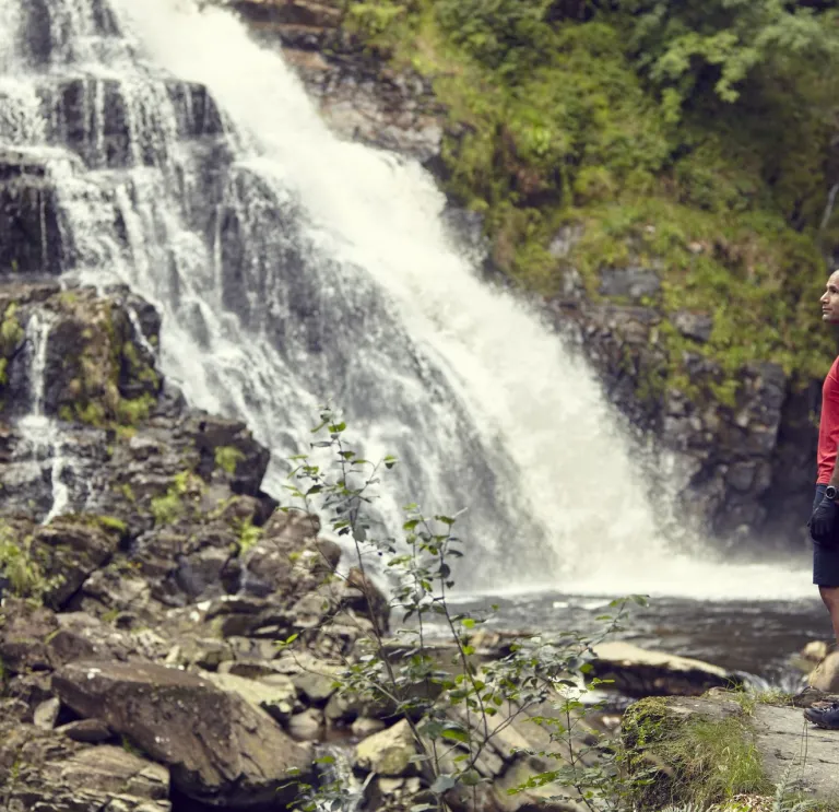 Richard Parks standing in front of a waterfall