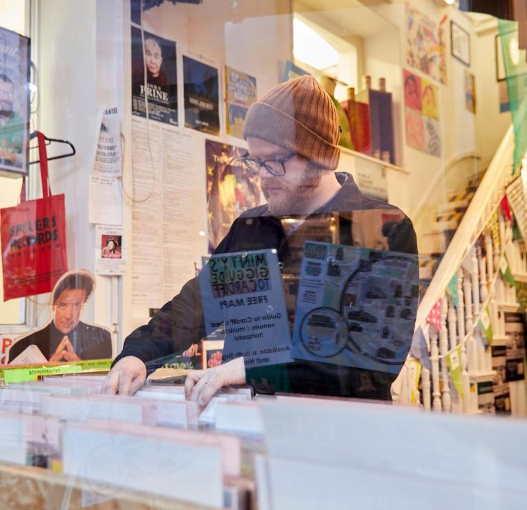Huw Stephens looking through records in Spillers, Cardiff's Victorian Arcades
