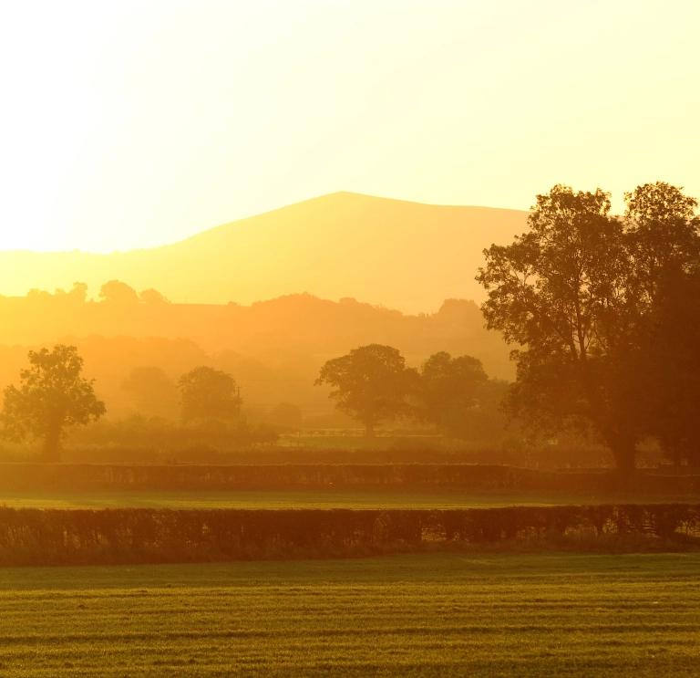 Image of a Welsh landscape at sunrise.