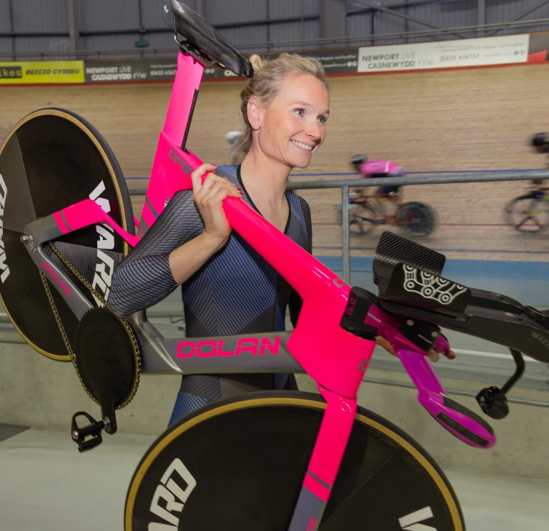 Ciara holding her bike over her shoulders