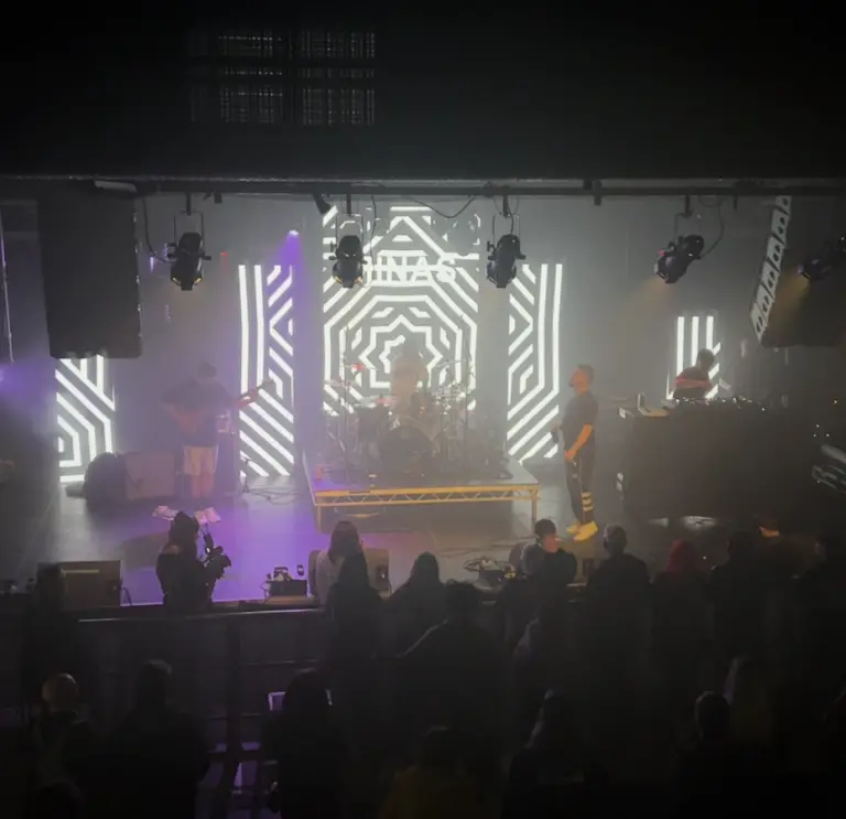 A band performing on a stage in front of a crowd