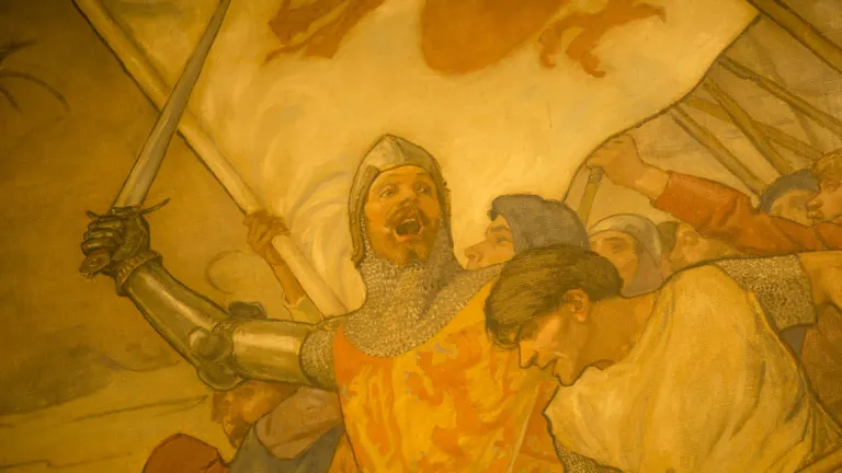 A painting of Owain Glyndwr in battle with a sword