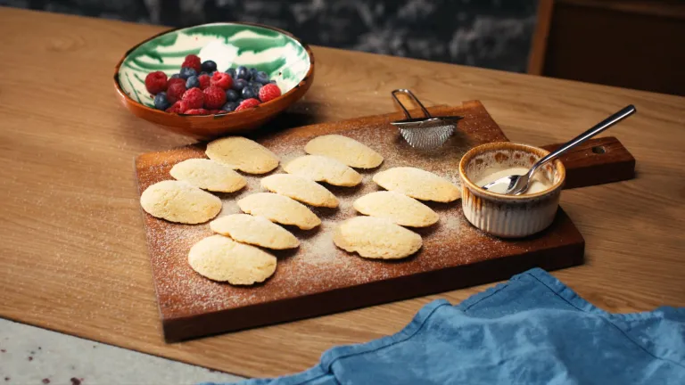 A beautifully presented wooden board with Welsh Aberffraw biscuits covered in sugar