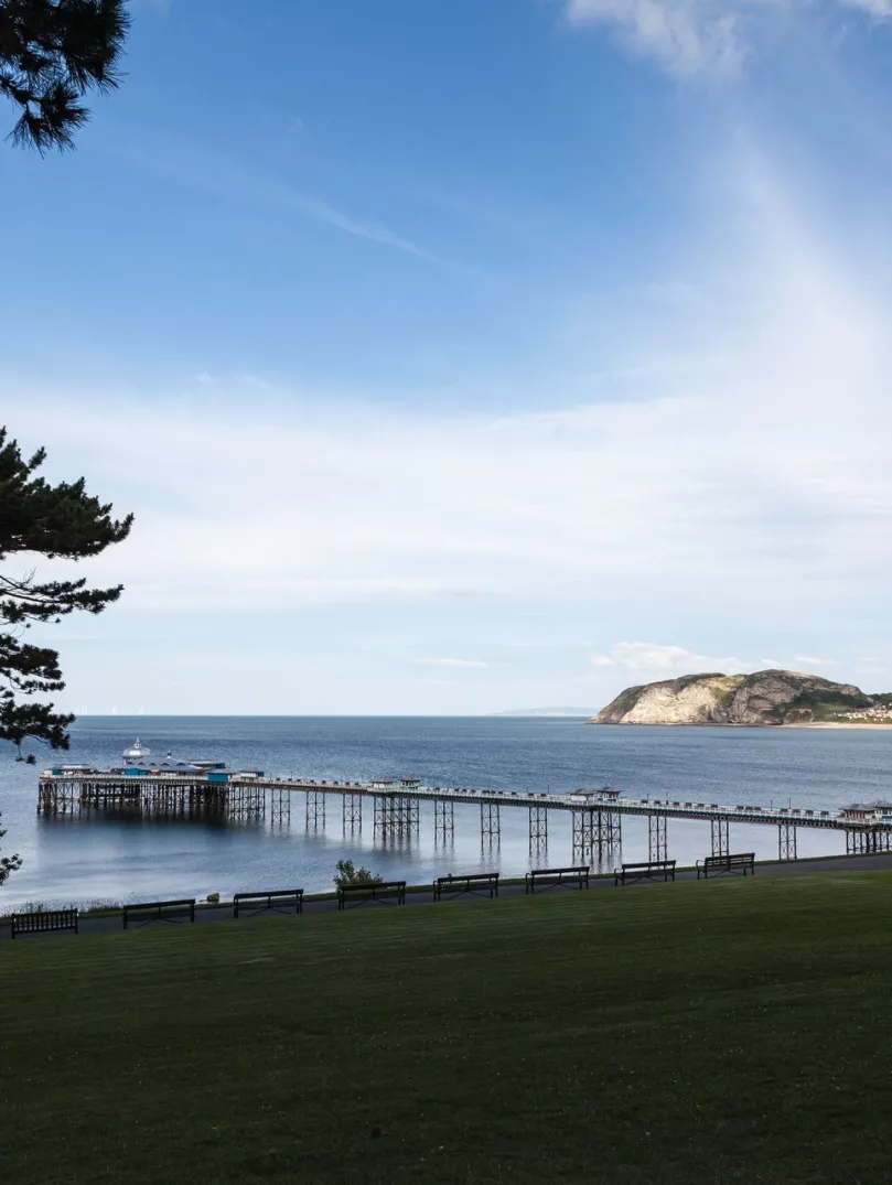 A view of the pier stretching out over blue water.