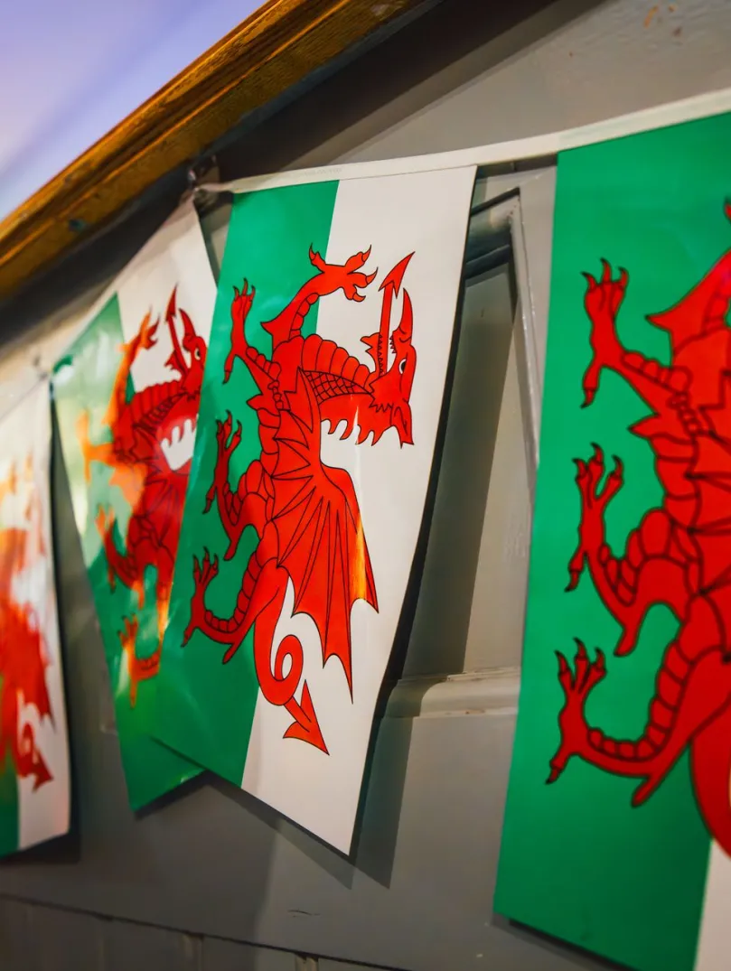 Welsh flags hanging on a wall.
