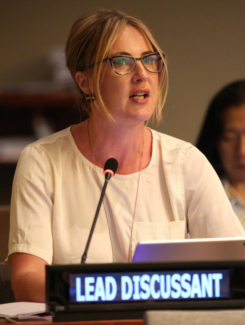 A woman sitting at a desk giving a statement