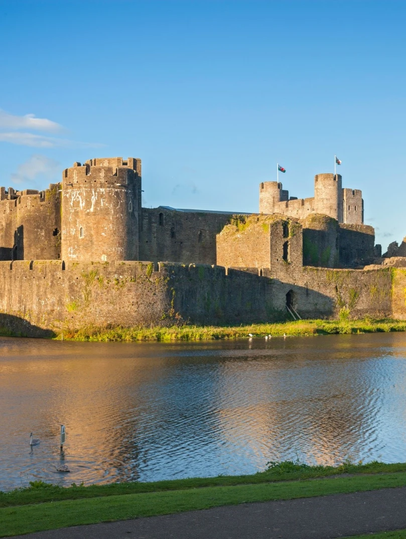 A large castle seen over a moat