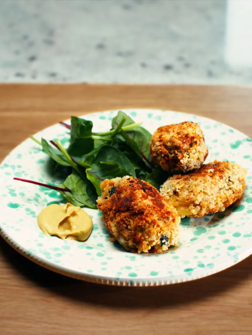 A beautifully presented plate of Glamorgan sausages with salad on the side