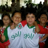 A group of children wearing Wales football shirts
