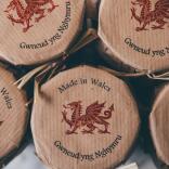 A row of glass jars with 'Made in Wales' and a red dragon stamped on top.