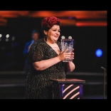 singer holding trophy.