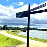 A signpost in front of the reservoir.