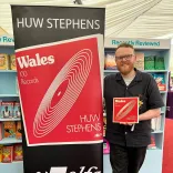 A man standing next to a banner.