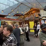 People standing around tables.