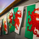 Welsh flags hanging on a wall.