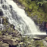 Richard Parks standing in front of a waterfall