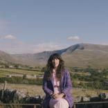 Lisa Jen sitting on a wall in Snowdonia.