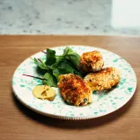 A beautifully presented plate of Glamorgan sausages with salad on the side
