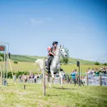 A rider on horseback reaching the end of the Man vs Horse race in Wales