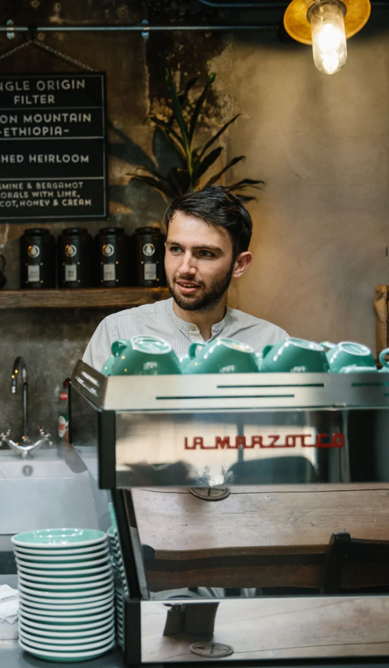 Making coffee for customer behind counter