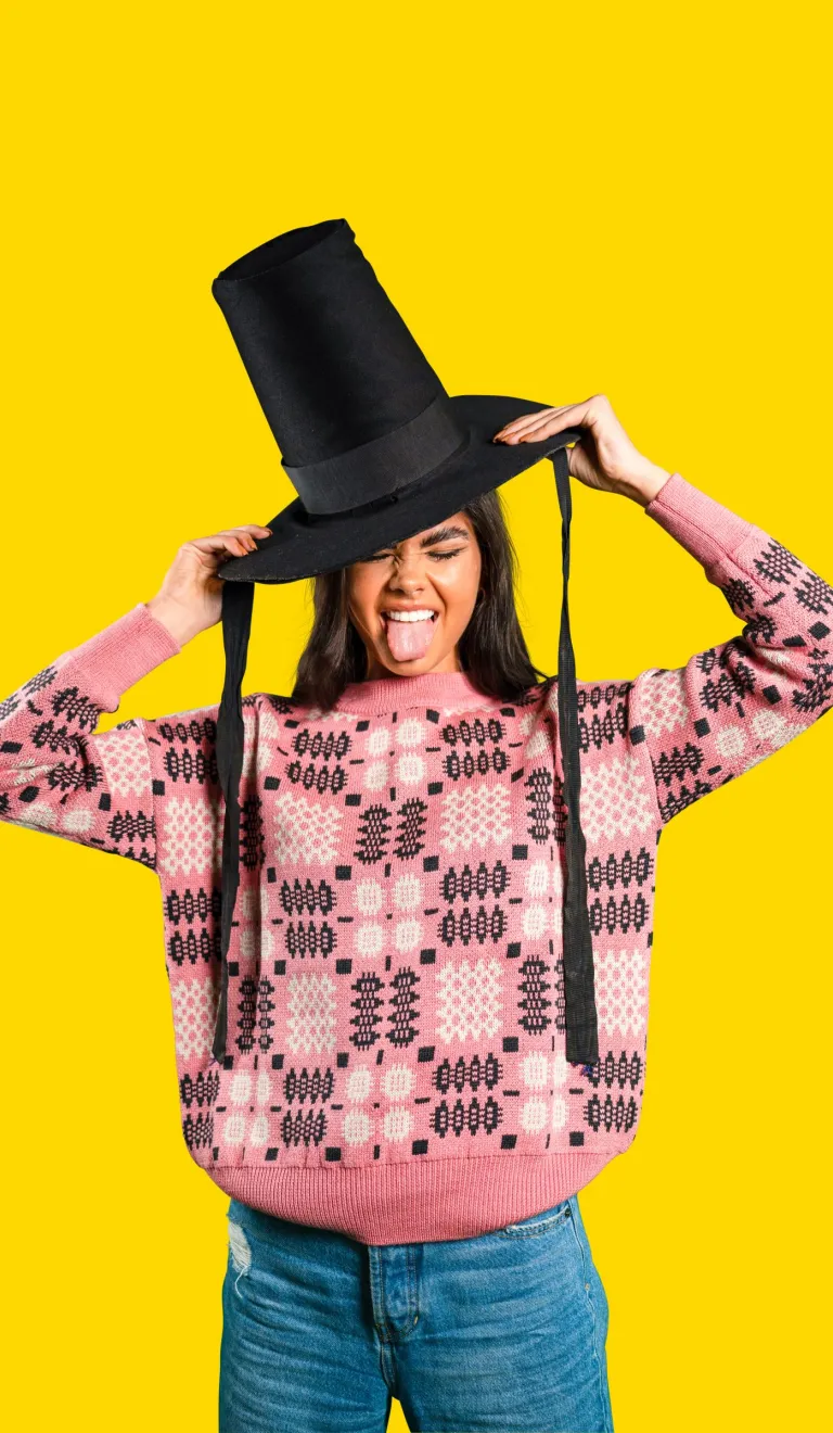 Woman wearing a Welsh hat and sticking her tongue out